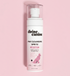 Divine Canine Paw Cleansing Spritz with rosewater bottle lying on a pink background